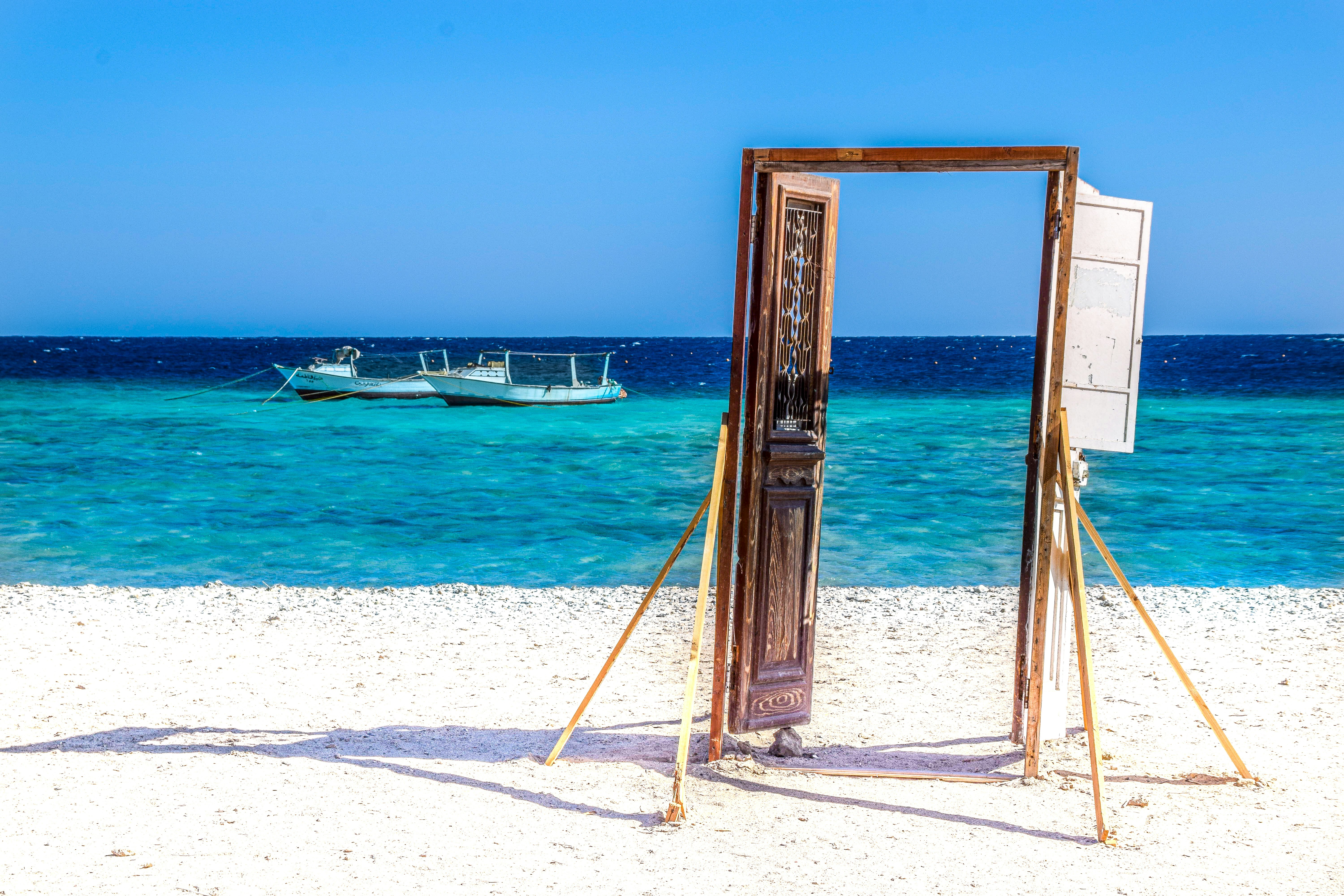 brown wooden frame on white sand beach during daytime